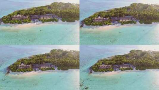 航拍海岛度假屋度假酒店沙滩海浪绿树林大海高清在线视频素材下载