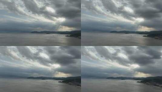 大海边阳光穿透乌云照在海面丁达尔光上帝光高清在线视频素材下载
