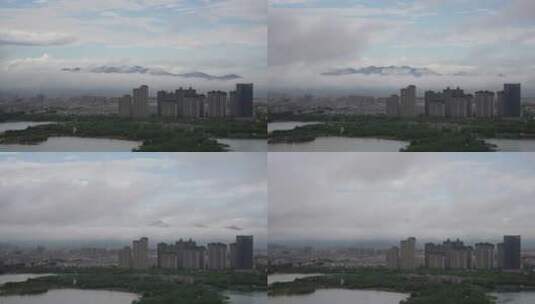 城市里天空下云层飘过遮住了群山4k延时高清在线视频素材下载