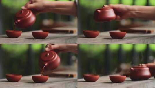 茶艺师拿起紫砂壶往茶杯里倒红茶高清在线视频素材下载