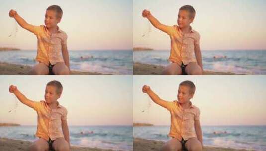 日落时分，孩子在海边玩沙子高清在线视频素材下载