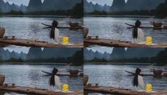 桂林漓江上的汉服小姐姐挑灯观察风景高清在线视频素材下载