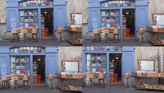 蓝色门头的法国二手书店，门外陈列里很多书高清在线视频素材下载