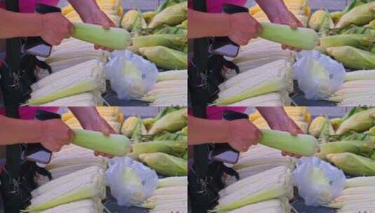 菜市场地摊挑选玉米的女人高清在线视频素材下载