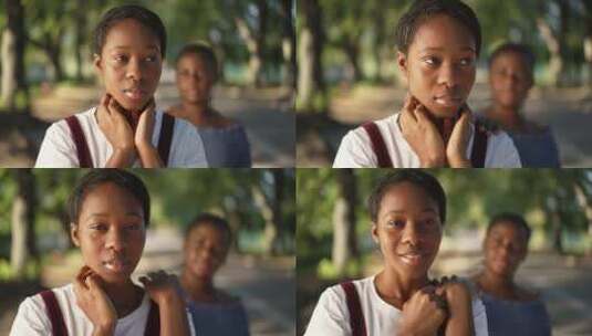 陷入困境的苗条年轻非裔美国妇女站在公园里高清在线视频素材下载