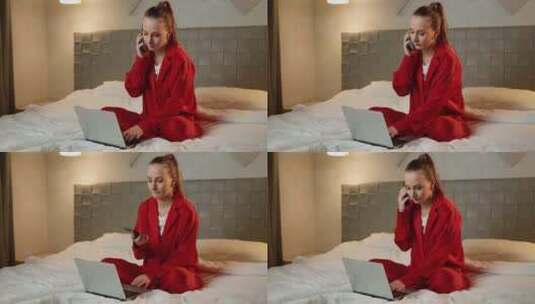 穿着红色睡衣的年轻女子晚上在卧室使用笔记高清在线视频素材下载