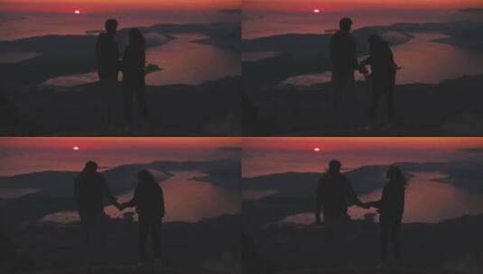 情侣在山顶牵手看风景剪影高清在线视频素材下载