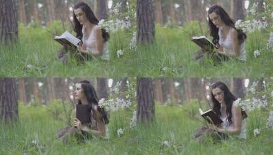 在草地上读书的女人高清在线视频素材下载