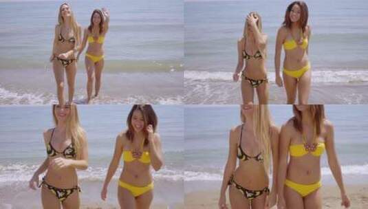 海滩上两个穿着比基尼的女人高清在线视频素材下载