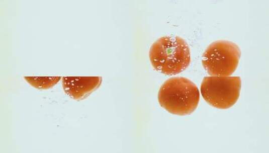 高速拍摄落入水中的西红柿高清在线视频素材下载