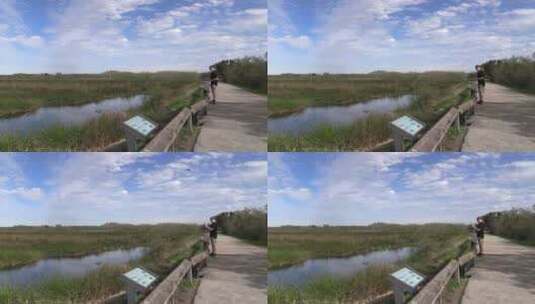 男人在池塘边拍摄高清在线视频素材下载