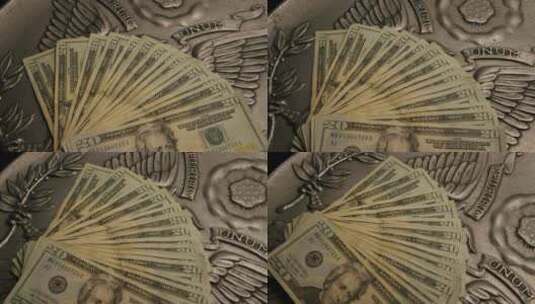 美国鹰盾背景上美国纸币的旋转镜头-MONEY 0401高清在线视频素材下载
