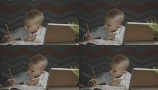 坐在桌边做作业的男孩高清在线视频素材下载