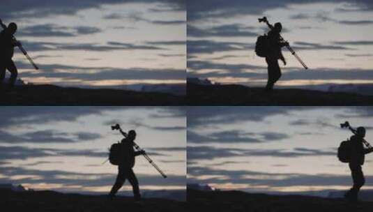 风光摄影师行走在夕阳里高清在线视频素材下载