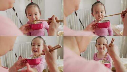 小女孩在家里吃饭大人用筷子喂饭高清在线视频素材下载