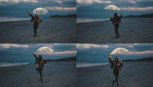 女孩在夜晚的海滩上拿着发光的雨伞跳舞高清在线视频素材下载