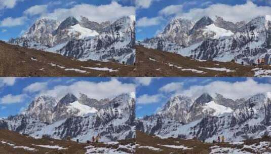 航拍垭口观看贡嘎山区雪山群峰的徒步旅行者高清在线视频素材下载