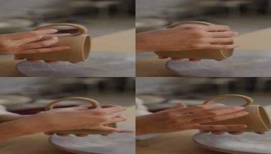 工匠将把手连接到手工粘土杯，背景是模糊的高清在线视频素材下载