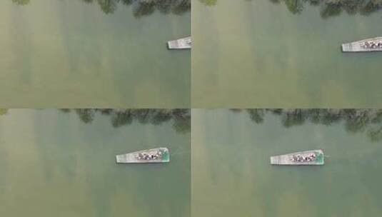 航拍初春江苏常熟尚湖景区水杉林与竹筏风光高清在线视频素材下载