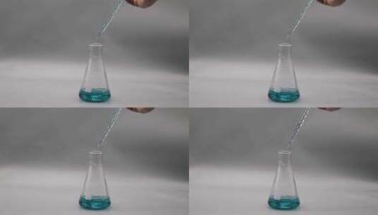 滴管向锥形瓶皿里浅蓝色溶液高清在线视频素材下载