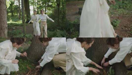 两个女人在树下寻找玻璃盒子高清在线视频素材下载