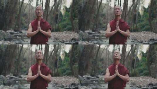 和尚在森林中双手合十祷告高清在线视频素材下载
