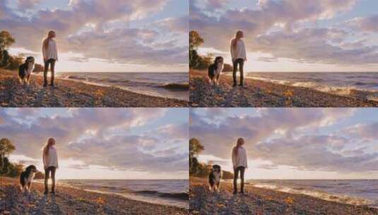 日落时海边牵着狗的女孩高清在线视频素材下载