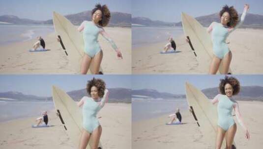女性在海滩上用冲浪板摆姿势高清在线视频素材下载