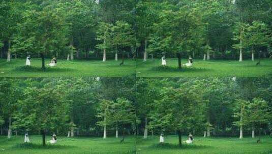 女孩在森林公园草地上拍照玩耍4k视频素材高清在线视频素材下载