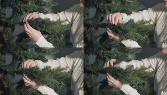 穿着毛衣的快乐女人伸直绿色圣诞树高清在线视频素材下载