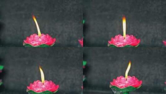 4K升格实拍寺庙里燃烧的莲花型蜡烛高清在线视频素材下载