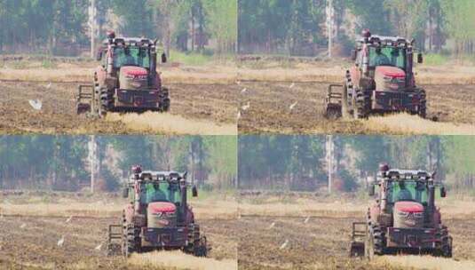 拖拉机耕作土地慢镜头高清在线视频素材下载