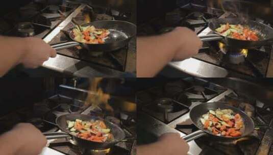 人摇晃平底锅在明火上混合蔬菜高清在线视频素材下载