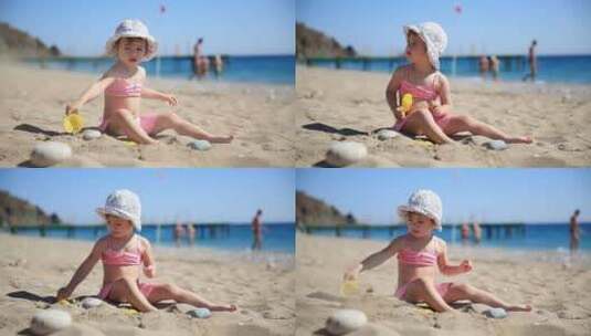 粉色泳衣的小女孩在海滩上玩高清在线视频素材下载