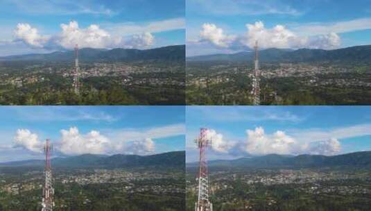 航拍山上的通讯塔和后面的城市高清在线视频素材下载