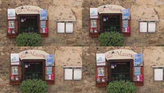 南法小镇，一个斑驳墙面的二手书店的窗口高清在线视频素材下载