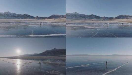 航拍女孩在新疆赛里木湖冰封蓝色湖面上行走高清在线视频素材下载