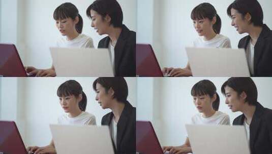 在电脑前交流的两个女人高清在线视频素材下载