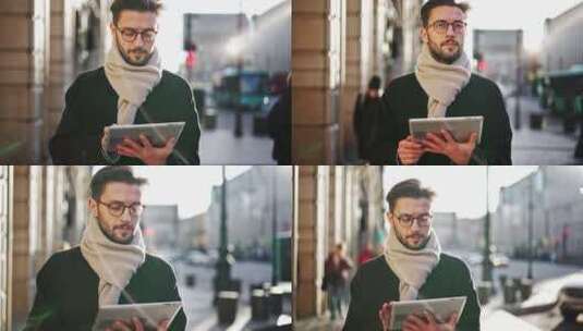 英俊的男人走在户外城市街道上，使用数字平板电脑进行交流或自由工作高清在线视频素材下载