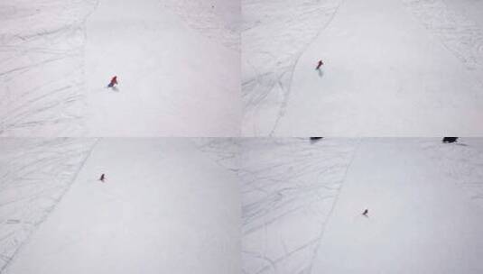 航拍滑雪者滑雪下坡高清在线视频素材下载