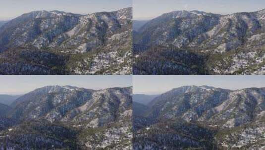 南加州白天惊人的雪和树木覆盖的山的航拍高清在线视频素材下载