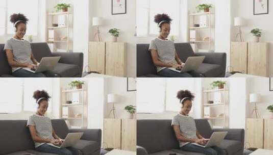 千禧一代非洲年轻女性在家使用笔记本电脑听音乐高清在线视频素材下载