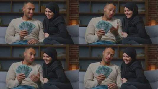 富有的穆斯林妇女和非裔美国男子所有者持有现金美元计划家庭预算赢钱高清在线视频素材下载