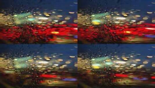 夜晚灯光下雨中行驶的车窗玻璃水珠空镜高清在线视频素材下载