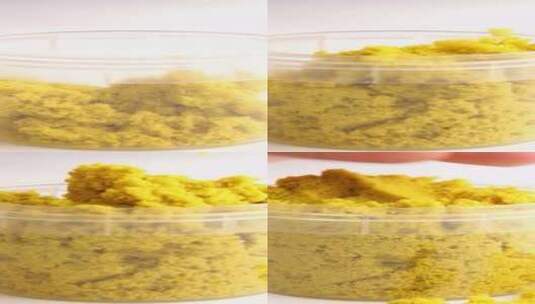 黄色动力沙散落在白色背景上Asmr高清在线视频素材下载