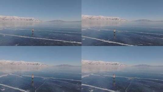 航拍女孩在新疆赛里木湖冰封蓝色湖面上行走高清在线视频素材下载