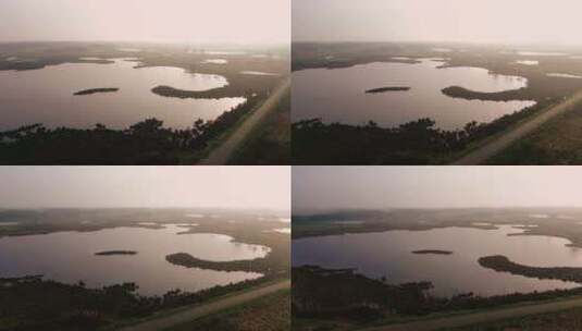 航拍日落前霞光照射在一望无际的平原湖泊高清在线视频素材下载