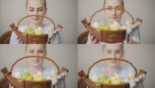 女人在室内直视镜头时展示一篮装饰好的鸡蛋高清在线视频素材下载