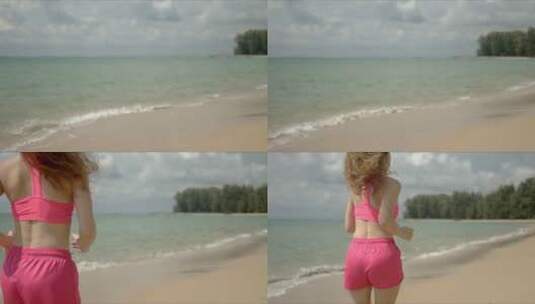 穿着粉色运动服在海滩上跑步的女人高清在线视频素材下载