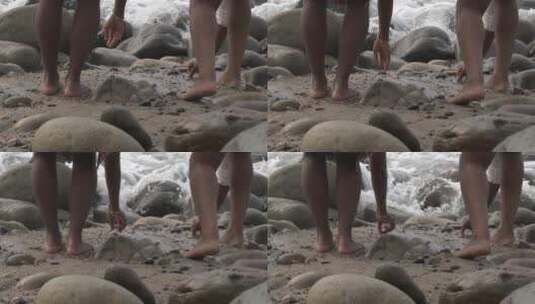 两个黑人妇女站在海滩上捡石头高清在线视频素材下载